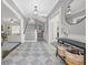 Bright entryway with stairs, console table and view into living room at 3953 Arkansas Ave Ne, St Petersburg, FL 33703