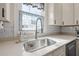 Kitchen features a farmhouse sink, stainless steel appliances, and white cabinetry at 3953 Arkansas Ave Ne, St Petersburg, FL 33703