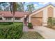Two-story home with a two-car garage and lush landscaping at 3979 Mermoor Dr, Palm Harbor, FL 34685