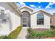 Exterior view of the house with walkway and landscaping at 4409 Whitton Way, New Port Richey, FL 34653