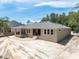 Spacious backyard view highlighting the home's exterior, patio, and well-lit windows at 5062 Elm Leaf Dr, Brooksville, FL 34601