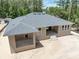 Rear view of the house featuring a patio, stairs, and multiple windows for natural light at 5062 Elm Leaf Dr, Brooksville, FL 34601