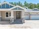 Inviting front entrance with stone accents and a covered porch with direct access to the garage at 5062 Elm Leaf Dr, Brooksville, FL 34601