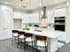 Modern kitchen featuring white cabinets, stainless steel appliances, and a central island with bar seating at 5062 Elm Leaf Dr, Brooksville, FL 34601