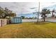 Large backyard with a storage shed and expansive lawn area at 5801 Venetian Ne Blvd, St Petersburg, FL 33703