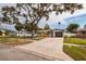 Single-story home with a large front yard and driveway, offering curb appeal at 5801 Venetian Ne Blvd, St Petersburg, FL 33703
