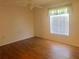 Bright bedroom with wood-look floors and window blinds at 12760 Indian Rocks Rd # 562, Largo, FL 33774