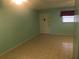 Spacious living room with light teal walls and tile floors at 12760 Indian Rocks Rd # 562, Largo, FL 33774