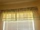 Window with patterned valance and white blinds at 12760 Indian Rocks Rd # 562, Largo, FL 33774