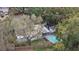 Aerial view of house featuring a pool, grill, and outdoor patio under tree coverage at 1504 E Mcberry St, Tampa, FL 33610