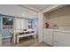 Bright dining area features a modern table with bench seating and adjacent laundry area at 1504 E Mcberry St, Tampa, FL 33610
