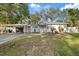 Charming single-story home boasts a carport, white brick exterior and mature trees at 1504 E Mcberry St, Tampa, FL 33610
