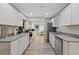 Modern kitchen features white cabinets, stainless appliances, and granite countertops at 1504 E Mcberry St, Tampa, FL 33610