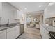 Modern open-concept kitchen featuring stainless steel appliances and granite countertops at 1504 E Mcberry St, Tampa, FL 33610
