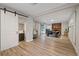 Large living room area featuring hardwood floors, fireplace, and access to a patio with sliding glass doors at 1504 E Mcberry St, Tampa, FL 33610