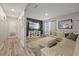 Comfortable living room featuring hardwood floors, large sectional couch and tv with built in shelving at 1504 E Mcberry St, Tampa, FL 33610