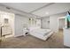 Spacious main bedroom boasts plush carpeting, ensuite bath, and serene decor at 1504 E Mcberry St, Tampa, FL 33610