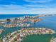 Wide aerial view of waterfront homes and high-rise buildings at 1637 Sand Key Estates Ct, Clearwater Beach, FL 33767