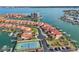 Aerial view of a waterfront community with tennis courts and private boat slips at 1637 Sand Key Estates Ct, Clearwater Beach, FL 33767