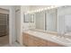 Double vanity bathroom with a large mirror and walk-in closet at 1637 Sand Key Estates Ct, Clearwater Beach, FL 33767