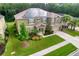 Two-story house with solar panels, landscaped yard, and driveway at 26888 Fiddlewood Loop, Wesley Chapel, FL 33544