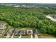 Aerial view of a neighborhood with a large green space and houses at 26888 Fiddlewood Loop, Wesley Chapel, FL 33544