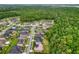Aerial view of neighborhood and surrounding nature at 26888 Fiddlewood Loop, Wesley Chapel, FL 33544