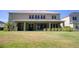 Large backyard with covered patio and lush grass at 26888 Fiddlewood Loop, Wesley Chapel, FL 33544