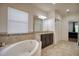 Bathroom with a large soaking tub and dark brown vanity at 26888 Fiddlewood Loop, Wesley Chapel, FL 33544