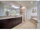 Bathroom with double sinks, a soaking tub, and tile flooring at 26888 Fiddlewood Loop, Wesley Chapel, FL 33544