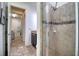 Bathroom with shower, tile flooring, and a vanity with a granite countertop at 26888 Fiddlewood Loop, Wesley Chapel, FL 33544