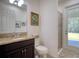 Bathroom with granite vanity, walk-in shower and private door to backyard at 26888 Fiddlewood Loop, Wesley Chapel, FL 33544