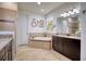 Bathroom with a soaking tub, double vanity, and walk-in shower at 26888 Fiddlewood Loop, Wesley Chapel, FL 33544