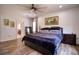 Spacious bedroom with a king-size bed and ensuite bathroom access at 26888 Fiddlewood Loop, Wesley Chapel, FL 33544