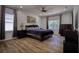 Main bedroom with large bed, wood floors, and plenty of light at 26888 Fiddlewood Loop, Wesley Chapel, FL 33544