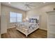 Charming bedroom featuring a floral comforter and white dresser at 26888 Fiddlewood Loop, Wesley Chapel, FL 33544