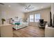 Bedroom with a queen-size bed, sunflower bedding, and workspace at 26888 Fiddlewood Loop, Wesley Chapel, FL 33544