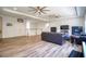 Bonus room with hardwood floors, a sofa, and built-in shelving at 26888 Fiddlewood Loop, Wesley Chapel, FL 33544