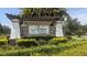 Arbor Woods community entrance with attractive landscaping at 26888 Fiddlewood Loop, Wesley Chapel, FL 33544