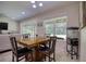 Bright dining area with wood table and four chairs, looks out to backyard at 26888 Fiddlewood Loop, Wesley Chapel, FL 33544