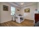 Bright home office with built-in desk and hardwood floors at 26888 Fiddlewood Loop, Wesley Chapel, FL 33544