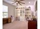 Home office with built-in shelving, desks, and carpeted flooring at 26888 Fiddlewood Loop, Wesley Chapel, FL 33544
