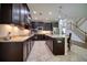 Modern kitchen with dark cabinets, stainless steel appliances, and an island at 26888 Fiddlewood Loop, Wesley Chapel, FL 33544