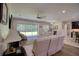 Spacious living room with comfortable seating, sliding glass doors and view of patio at 26888 Fiddlewood Loop, Wesley Chapel, FL 33544