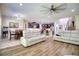 Open living room with comfortable seating and a view of the kitchen and stairs at 26888 Fiddlewood Loop, Wesley Chapel, FL 33544