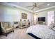 Main bedroom with a sitting area and large windows at 26888 Fiddlewood Loop, Wesley Chapel, FL 33544