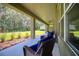 Spacious patio with wicker chairs and a view of the backyard at 26888 Fiddlewood Loop, Wesley Chapel, FL 33544