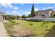 Large backyard with grassy area and boat on trailer at 3276 Sea Grape Dr, Hernando Beach, FL 34607