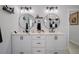 Double vanity bathroom with white cabinets and marble countertops at 3276 Sea Grape Dr, Hernando Beach, FL 34607
