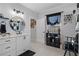 Modern bathroom with white vanity, round mirror, and black accents at 3276 Sea Grape Dr, Hernando Beach, FL 34607